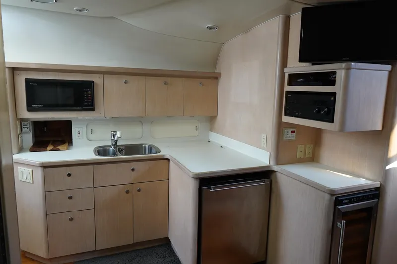 Slide: The Image of 1994 Tiara Yachts 4000 Express kitchen with microwave, sink, and cabinetry. - 21