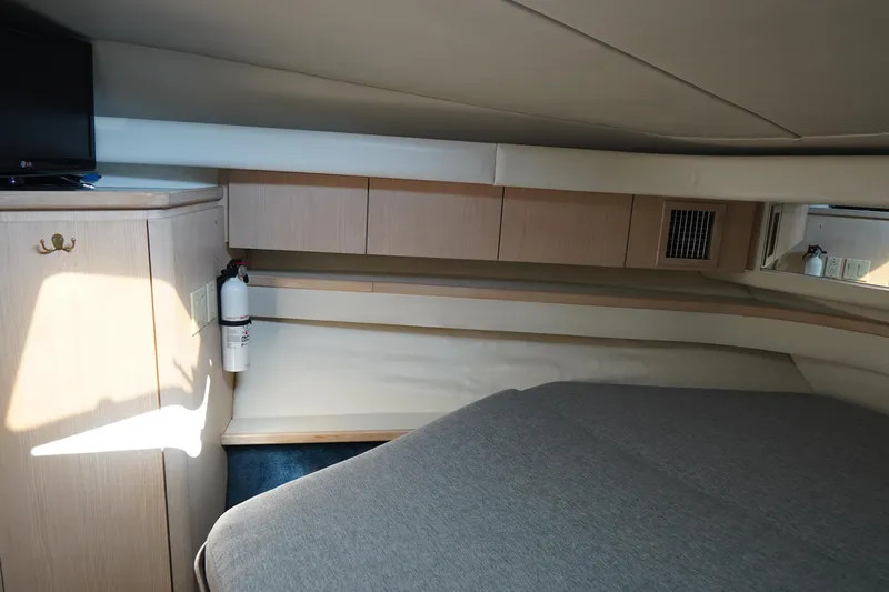 Slide: The Image of Interior cabin of 1994 Tiara Yachts 4000 Express, featuring bed and storage cabinets. - 24