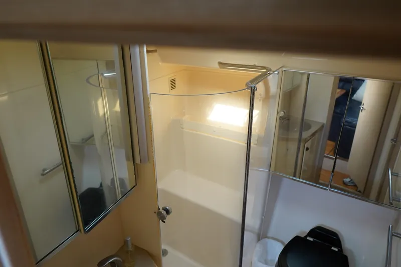 Slide: The Image of Bathroom interior of 1994 Tiara Yachts 4000 Express, featuring shower and mirrored cabinets. - 26