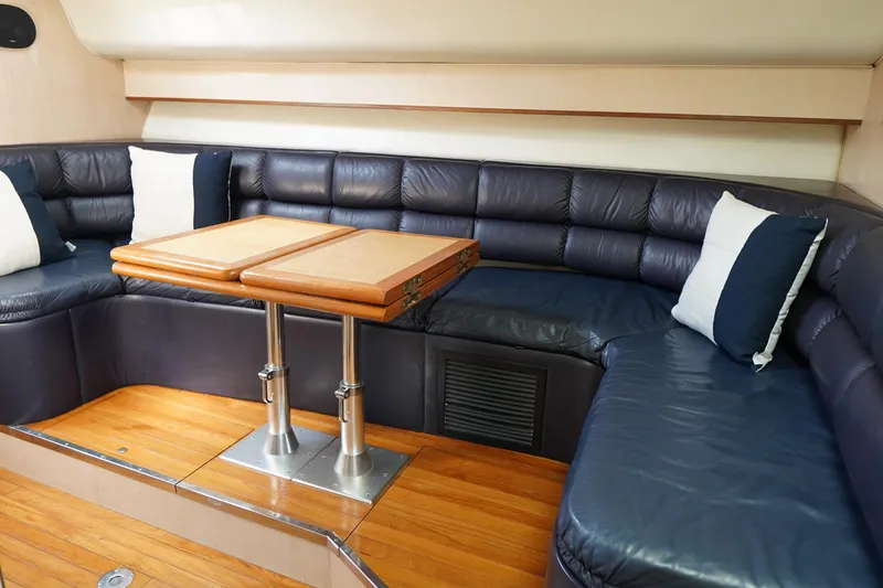 Slide: The Image of Luxurious interior of 1994 Tiara Yachts 4000 Express with leather seating and wooden table. - 27
