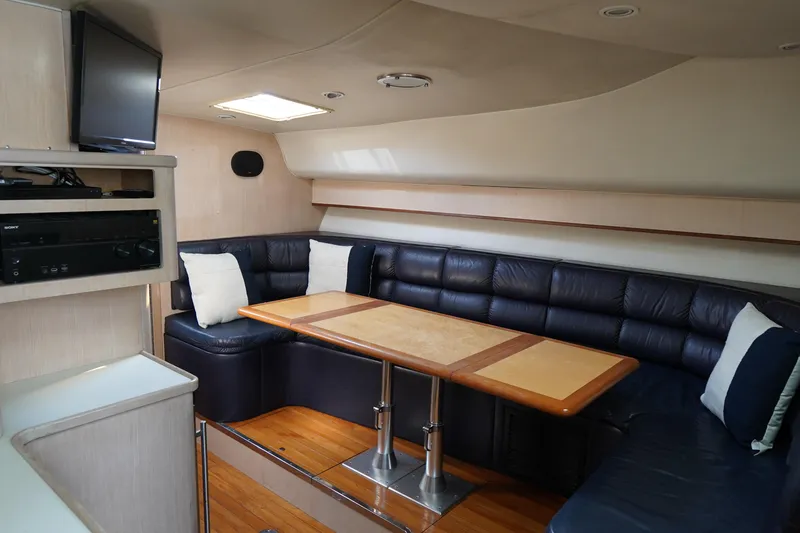 Slide: The Image of Luxurious interior of 1994 Tiara Yachts 4000 Express with leather seating and wooden table. - 28