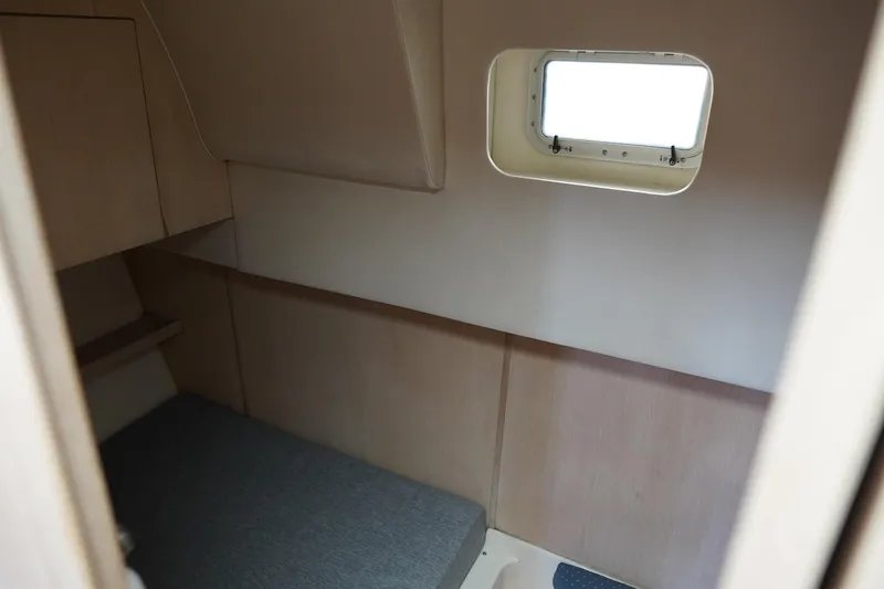 Slide: The Image of 1994 Tiara Yachts 4000 Express cabin interior with window and bed. - 29