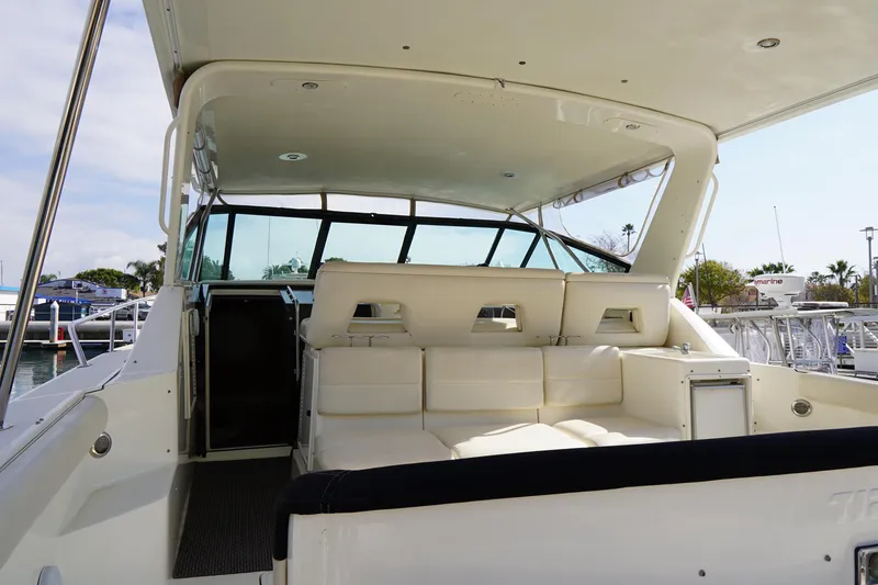 Slide: The Image of 1994 Tiara Yachts 4000 Express interior with white seating and open cockpit view. - 32