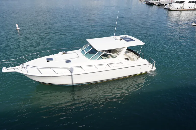 Slide: The Image of 1994 Tiara Yachts 4000 Express cruising on calm blue waters. - 8