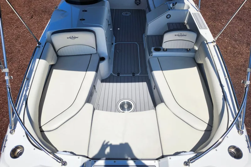 Slide: The Image of 2024 Stingray 212 SC boat interior with spacious seating and modern design. - 14