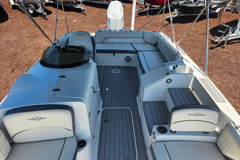 Slide: The Image of 2024 Stingray 212 SC boat interior with spacious seating and modern design. - 15