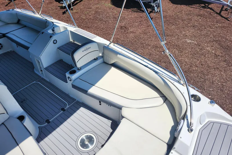 Slide: The Image of 2024 Stingray 212 SC boat interior with spacious seating and sleek design. - 16