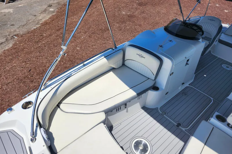 Slide: The Image of 2024 Stingray 212 SC boat interior with sleek seating and modern design. - 17