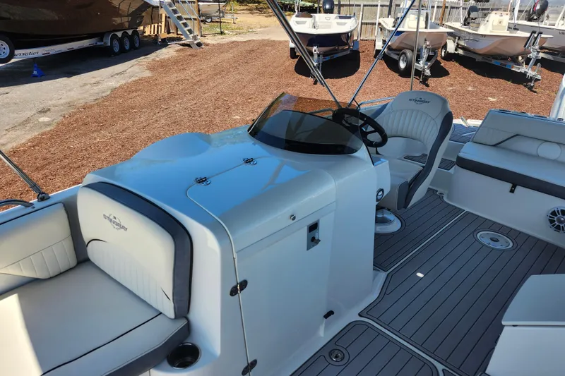 Slide: The Image of 2024 Stingray 212 SC boat interior with seating and steering console. - 18