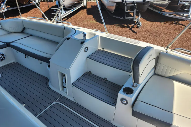 Slide: The Image of 2024 Stingray 212 SC boat interior with seating and storage compartments. - 19