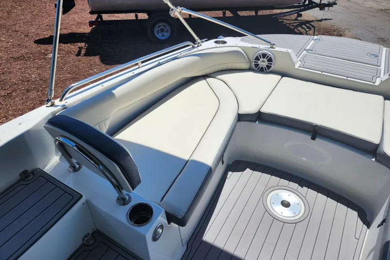 Slide: The Image of 2024 Stingray 212 SC boat interior with cushioned seating and sleek design. - 25