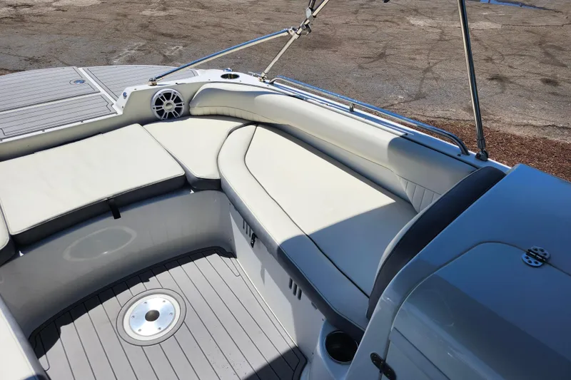 Slide: The Image of 2024 Stingray 212 SC boat interior with cushioned seating and sleek design. - 26