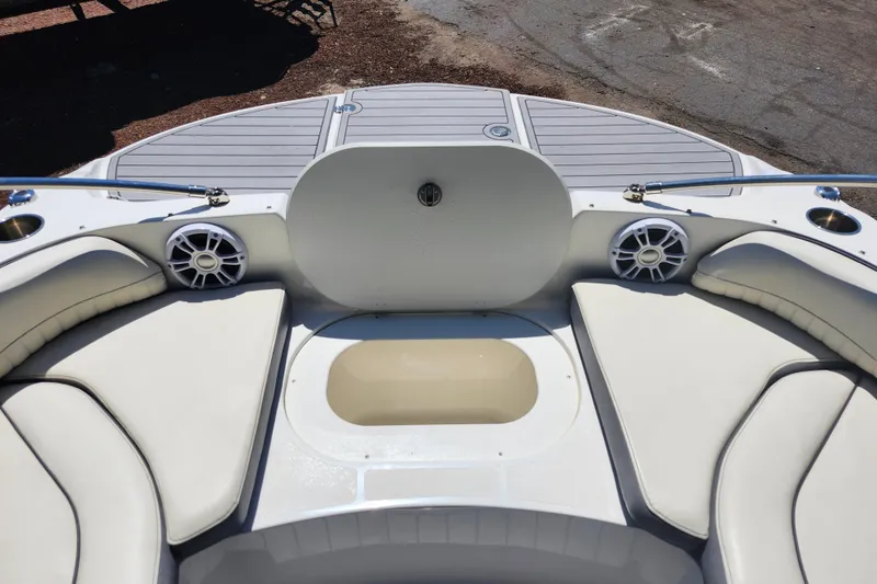 Slide: The Image of 2024 Stingray 212 SC boat interior with cushioned seating and speakers. - 27