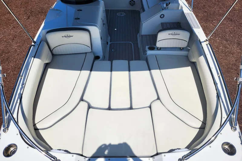 Slide: The Image of 2024 Stingray 212 SC boat interior with spacious seating and sleek design. - 30