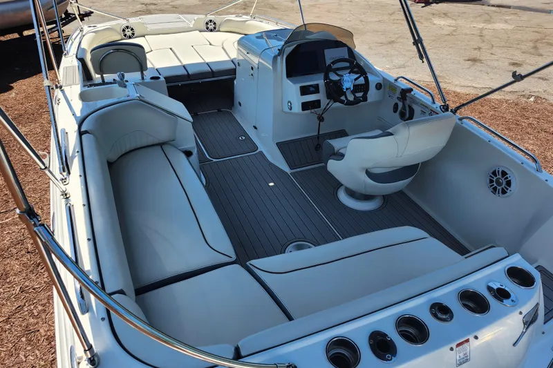 Slide: The Image of 2024 Stingray 212 SC boat interior with seating, steering wheel, and dashboard. - 39