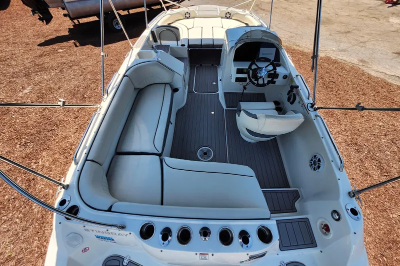 Slide: The Image of 2024 Stingray 212 SC boat interior with spacious seating and modern helm. - 40