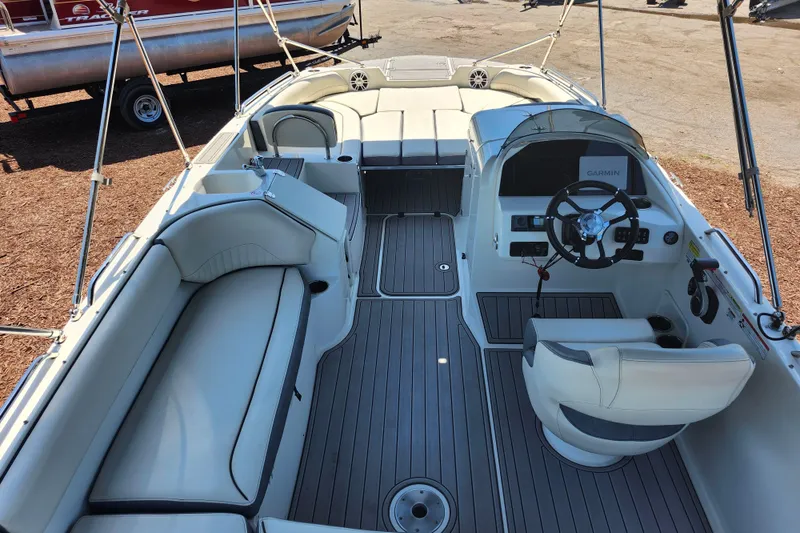 Slide: The Image of 2024 Stingray 212 SC boat interior with seating and steering console. - 41