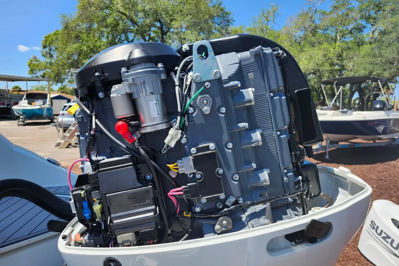 Slide: The Image of 2024 Stingray 212 SC boat engine close-up, showcasing intricate mechanical components. - 47