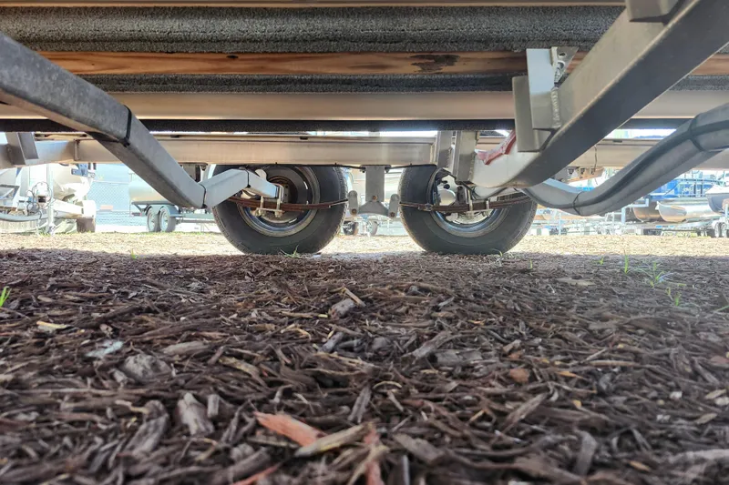 Slide: The Image of Underside view of 2024 Stingray 212 SC trailer, showcasing wheels and suspension system. - 49
