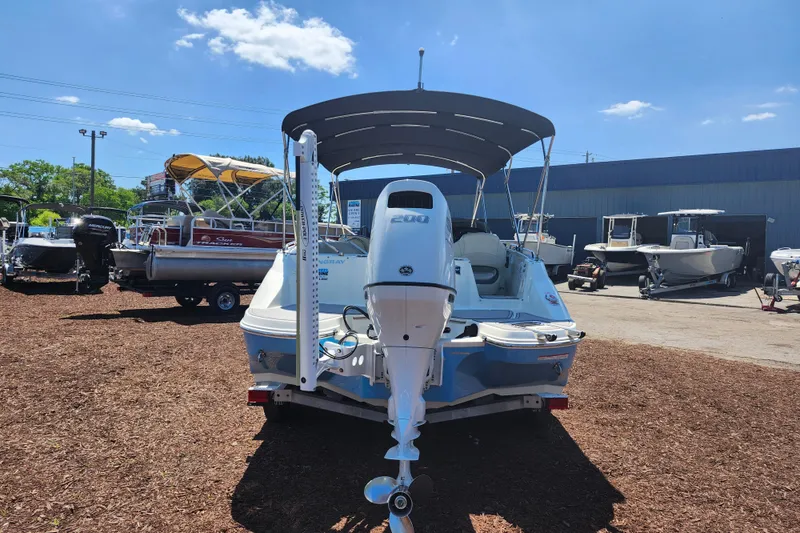 Slide: The Image of 2024 Stingray 212 SC boat with outboard motor in a dealership lot. - 6