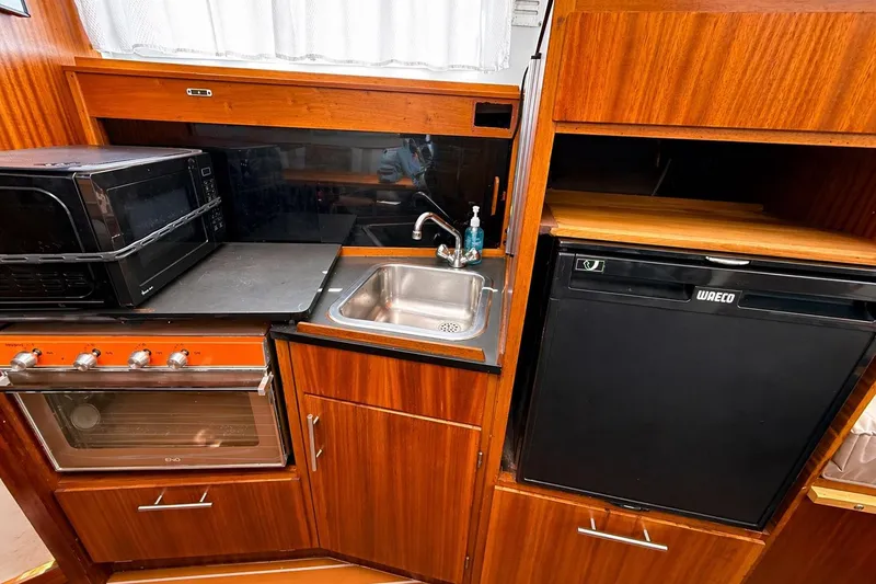 Slide: The Image of 1975 Apollo 32 Deluxe TT engine compartment with visible wiring and components. - 18