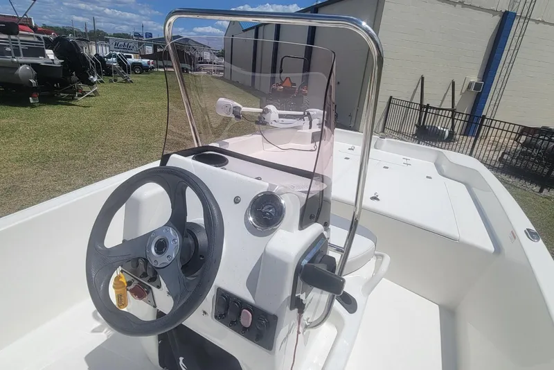 Slide: The Image of 2024 Mako Pro Skiff 17 CC boat interior with steering wheel and console. - 11