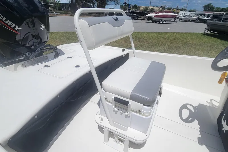 Slide: The Image of 2024 Mako Pro Skiff 17 CC boat interior with seating and Mercury engine. - 12