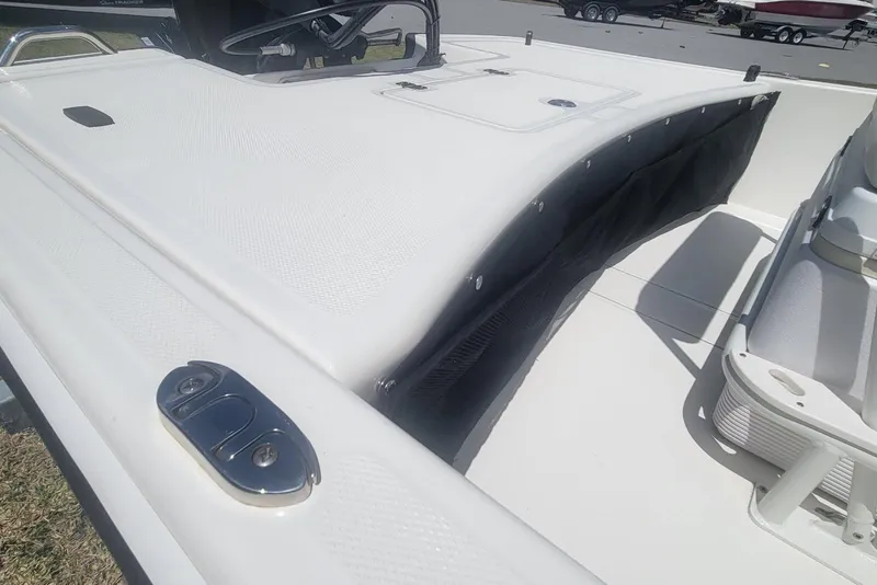 Slide: The Image of 2024 Mako Pro Skiff 17 CC boat deck with storage and seating area. - 13