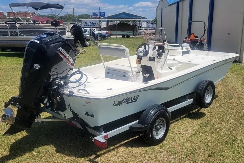 Slide: The Image of 2024 Mako Pro Skiff 17 CC boat with Mercury engine on trailer, parked outdoors. - 4