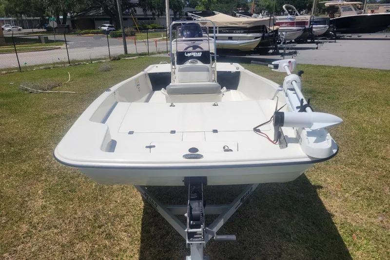Slide: The Image of 2024 Mako Pro Skiff 17 CC boat on trailer, parked on grass. - 5