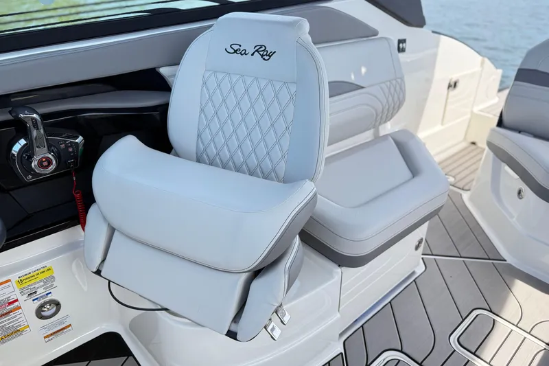Slide: The Image of 2023 Sea Ray SLX 260 boat interior with luxurious seating and modern controls. - 11