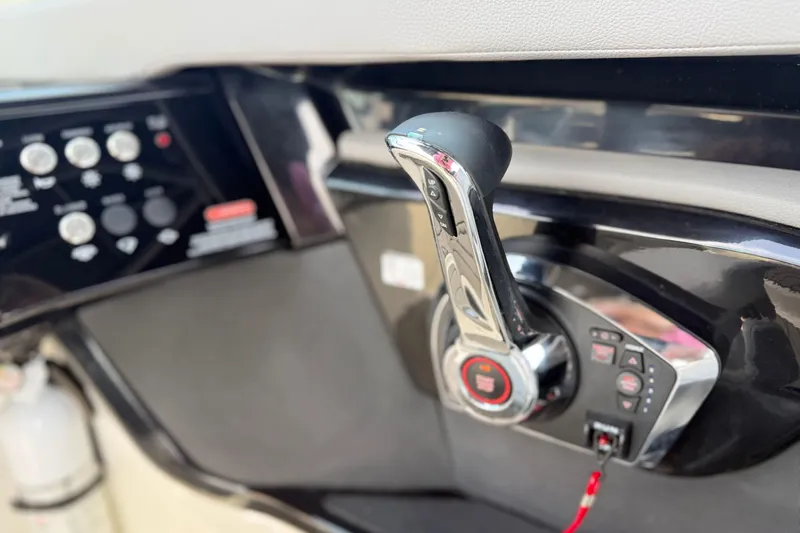 Slide: The Image of Close-up of 2023 Sea Ray SLX 260 boat control panel and throttle lever. - 13