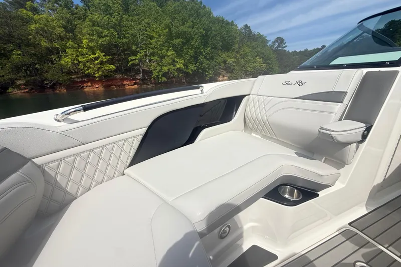 Slide: The Image of Luxurious seating on 2023 Sea Ray SLX 260 boat with scenic lake view. - 18