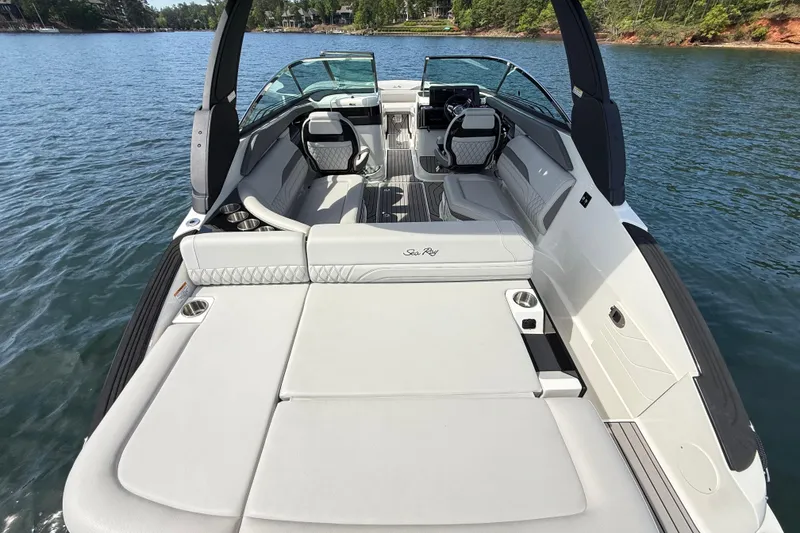Slide: The Image of 2023 Sea Ray SLX 260 boat interior with luxurious seating on a serene lake. - 5