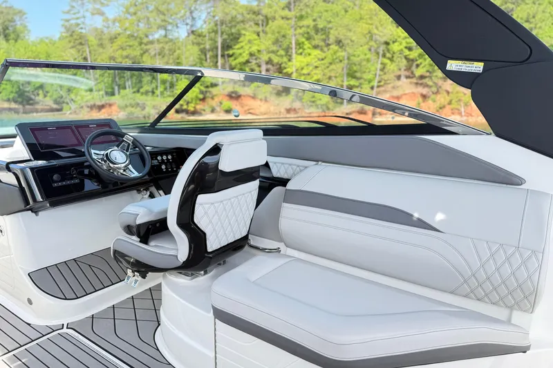 Slide: The Image of 2023 Sea Ray SLX 260 boat interior with modern steering and luxurious seating. - 9