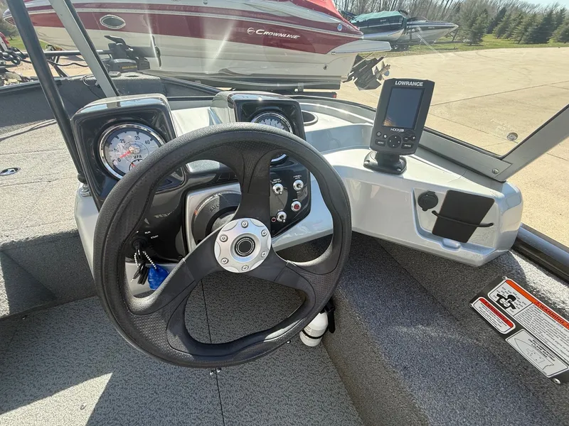 Slide: The Image of Steering wheel and dashboard of a 2017 Tracker Pro Guide V-16 WT. - 11