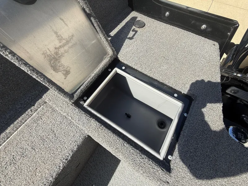 Slide: The Image of 2017 Tracker Pro Guide V-16 WT boat with open storage compartment. - 21