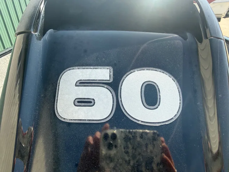 Slide: The Image of Close-up of a 60 HP engine on Tracker Pro Guide V-16 WT. - 23