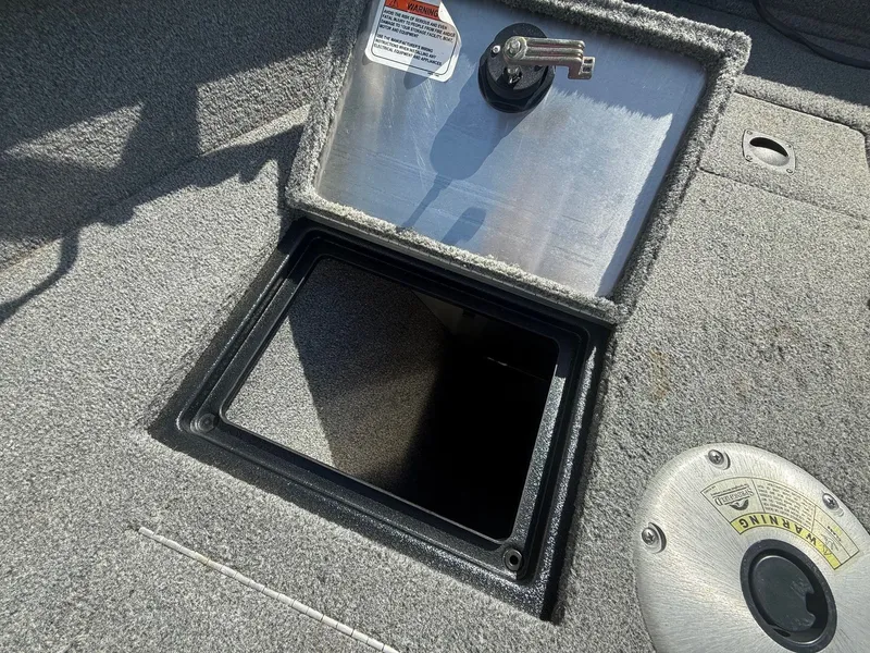 Slide: The Image of 2017 Tracker Pro Guide V-16 WT boat with open storage compartment. - 7