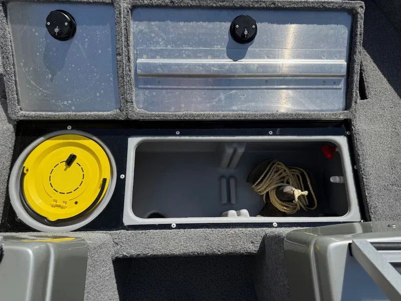 Slide: The Image of 2017 Tracker Pro Guide V-16 WT boat storage with rope and yellow lid. - 9