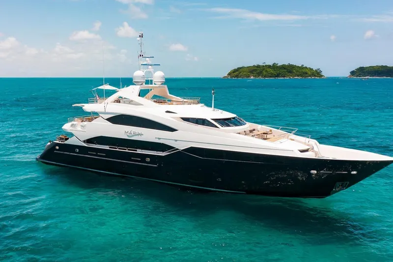 The Image of Luxurious 2014 Sunseeker 131 Yacht cruising in turquoise waters near lush islands. - 0
