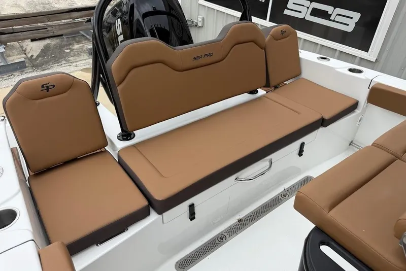 Slide: The Image of 2026 Sea Pro 225FLX Sandbar boat interior with brown cushioned seating. - 12