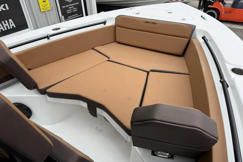 Slide: The Image of 2026 Sea Pro 225FLX Sandbar boat interior with tan cushioned seating. - 15