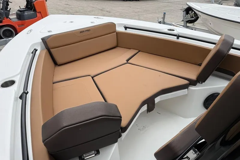 Slide: The Image of 2026 Sea Pro 225FLX Sandbar boat with tan cushioned seating in the bow area. - 17