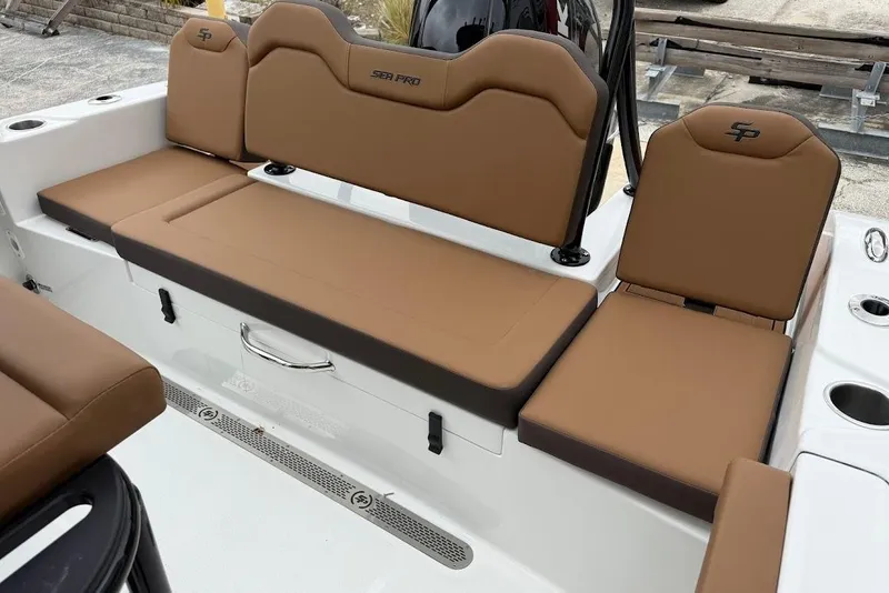 Slide: The Image of 2026 Sea Pro 225FLX Sandbar boat interior with brown cushioned seating. - 18