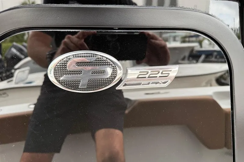 Slide: The Image of 2026 Sea Pro 225FLX Sandbar boat emblem with reflective surface. - 19