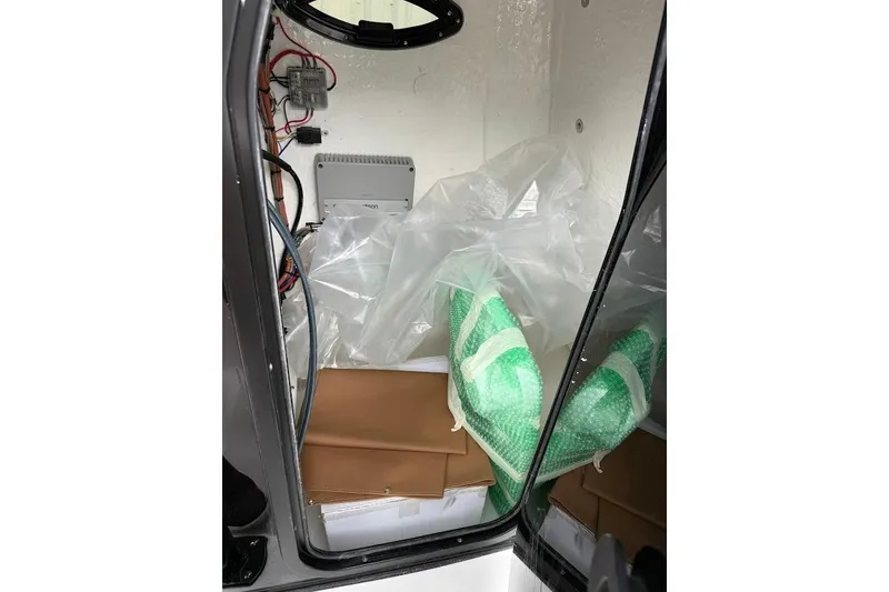 Slide: The Image of Interior storage compartment of 2026 Sea Pro 225FLX Sandbar boat with equipment and packaging. - 20