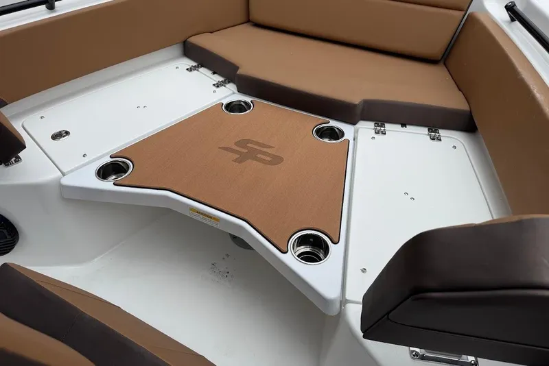 Slide: The Image of Interior of 2026 Sea Pro 225FLX Sandbar boat with brown seating and table. - 21