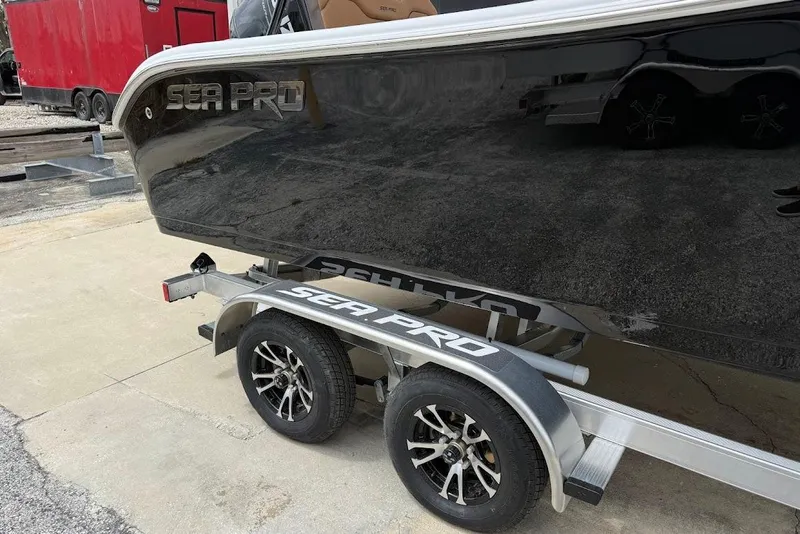 Slide: The Image of 2026 Sea Pro 225FLX Sandbar boat on trailer, featuring sleek black design. - 3