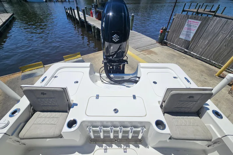 Slide: The Image of 2022 Sea Pro 228 Bay boat at dock, featuring spacious seating and powerful outboard motor. - 14